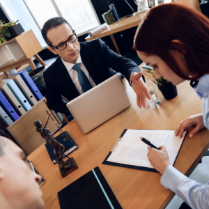 An adviser handing a divorced couple pension fun management documents